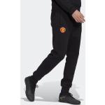 Pantaloni tuta scontati neri XS in poliestere sostenibili per Uomo adidas Essentials Manchester United 